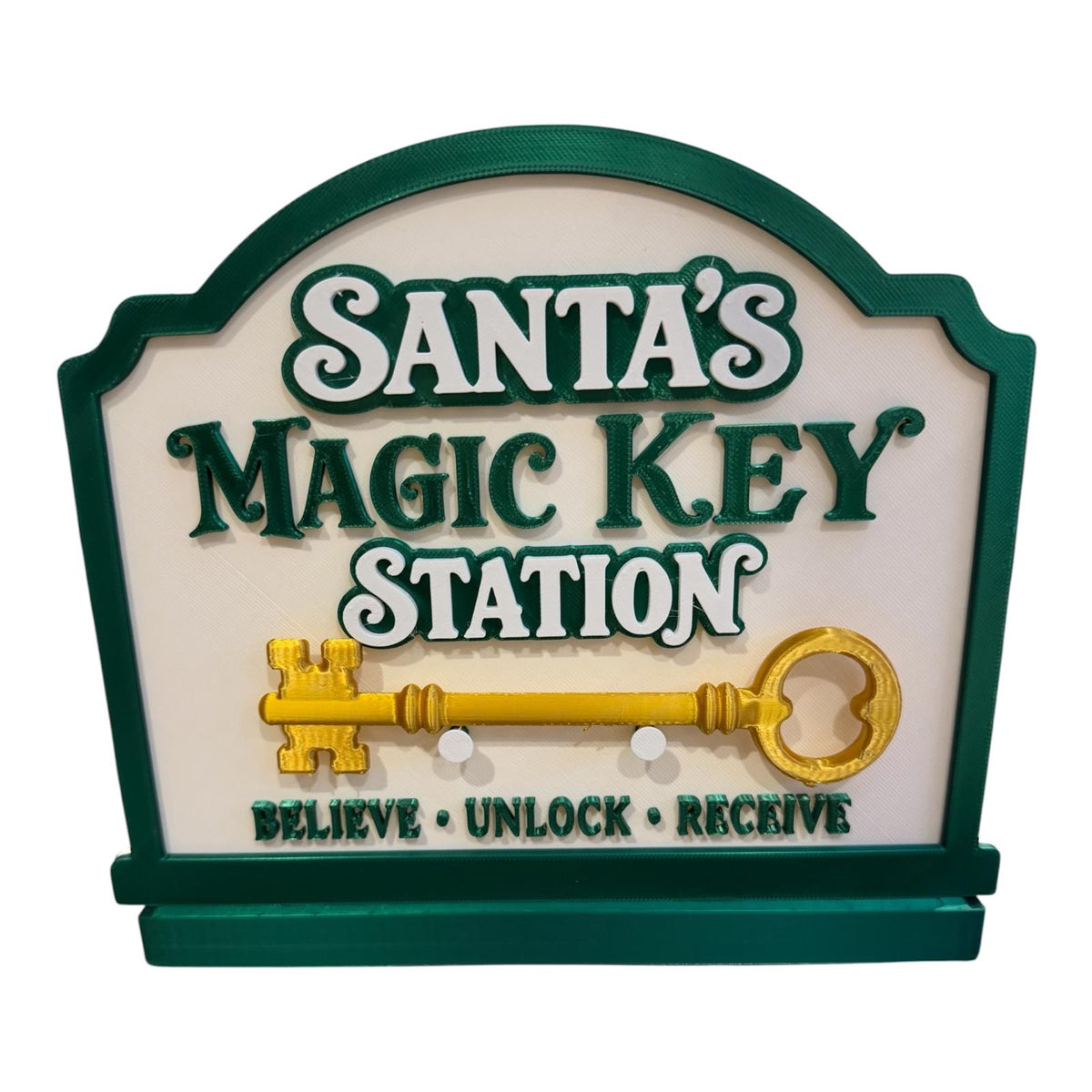 Green and cream Santa’s Magic Key Station with a loose gold-coloured key resting on the front