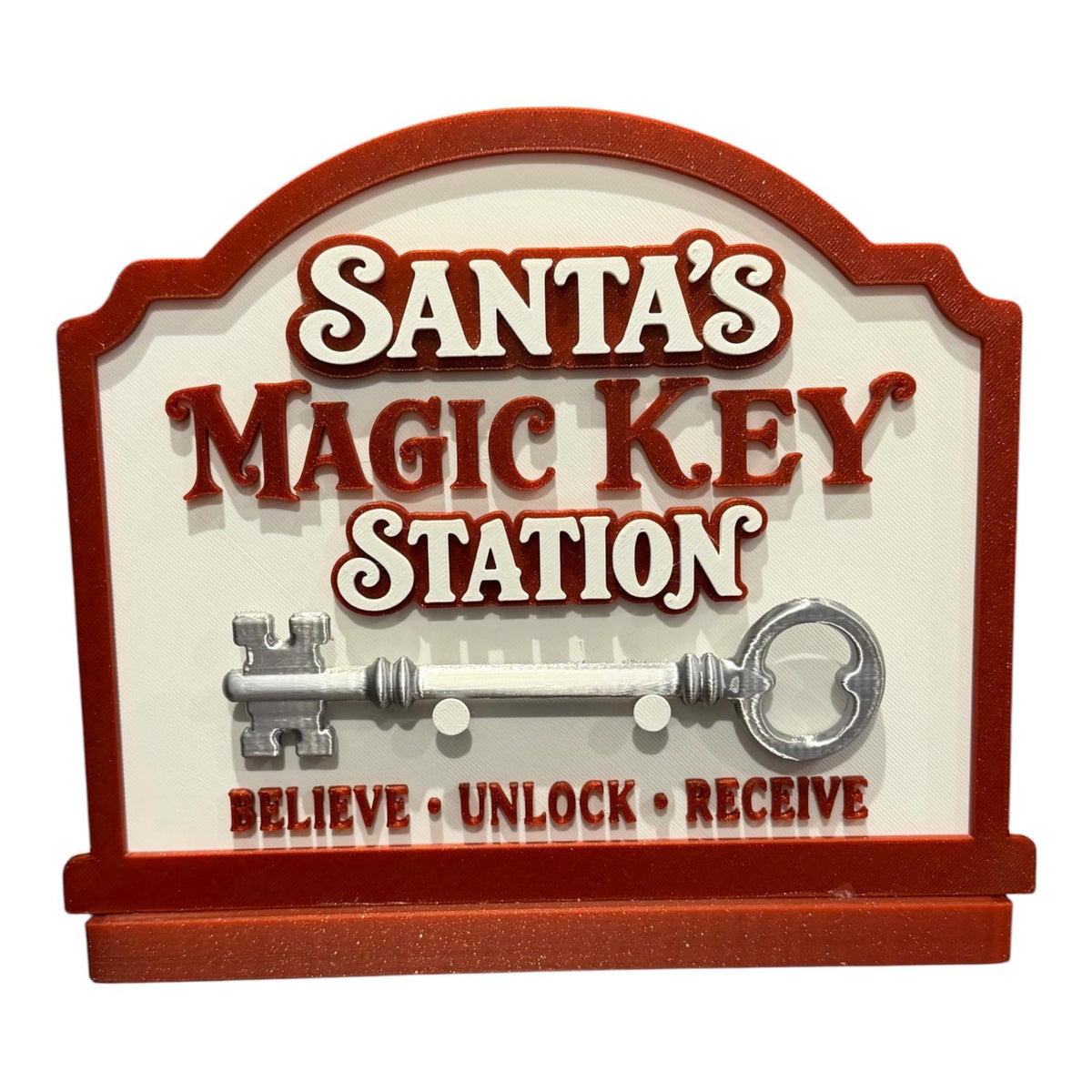 Red and cream Santa’s Magic Key Station with a loose silver-coloured key resting on the front